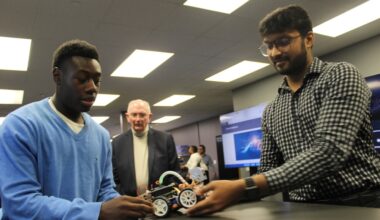 Two students showcasing a robot program