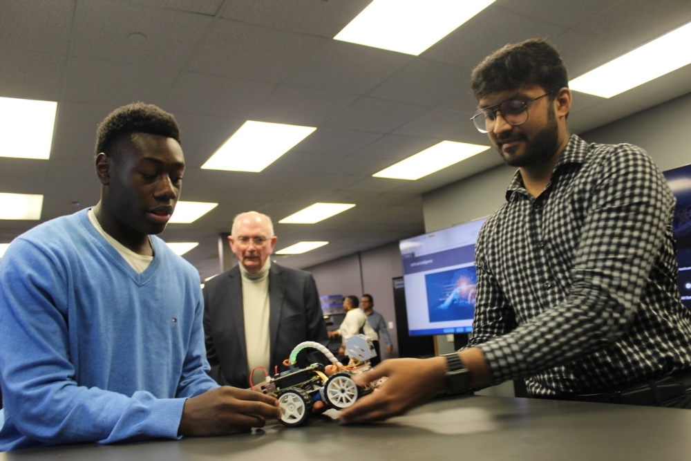 Two students showcasing a robot program