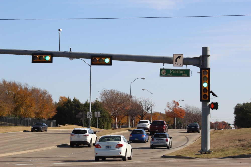Cars driving past at an intersection labeled "Preston"