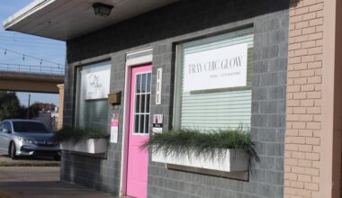 A storefront with a bright pink door