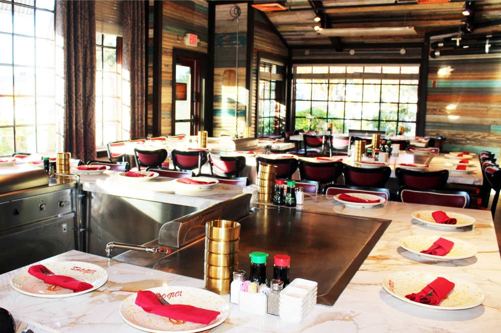 Tables set up for a hibachi experience in a restaurant.