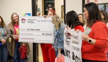 Teachers receiving an oversized grant check