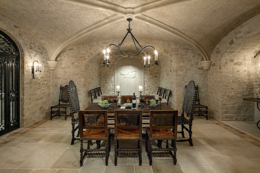 Stone surrounded room with dining table in wine cellar
