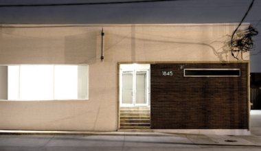 A night image of a one-story gallery building.