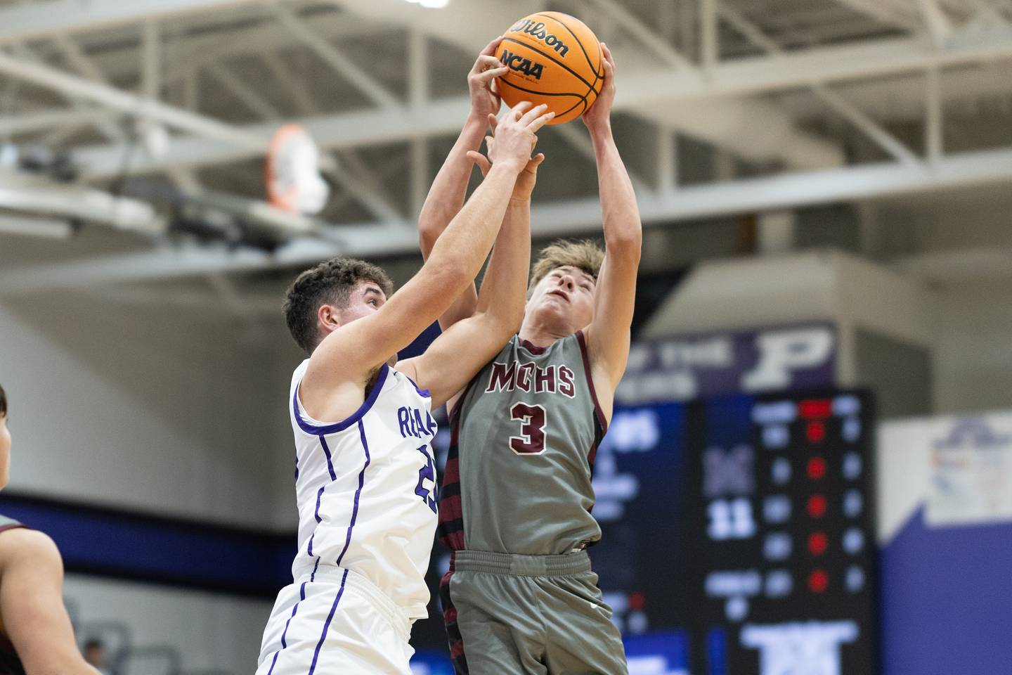 Plano's Cooper Beaty (23, left) battles for a rebound with Marengo's Caden Bezik (3) during Wednesday's game in Plano.