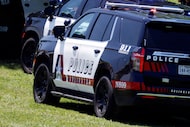 A file photo shows an Arlington police vehicle. A person is dead and another is injured...
