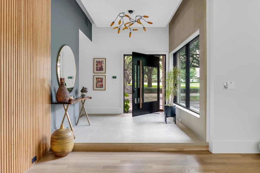 residential entry with black door and white and blue walls