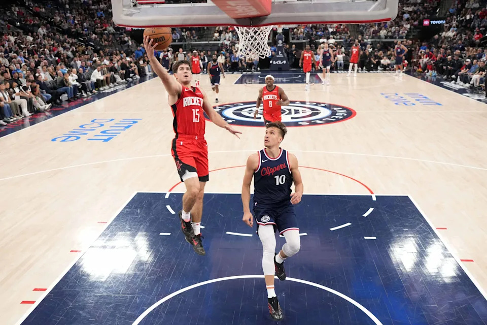 Apr 9, 2025; Inglewood, California, USA; Houston Rockets guard Reed Sheppard (15) shoots the ball against LA Clippers guard Bogdan Bogdanovic (10) in the first half at the Intuit Dome. Mandatory Credit: Kirby Lee-Imagn Images