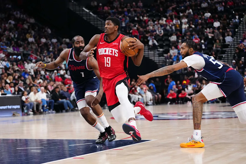 Apr 9, 2025; Inglewood, California, USA; Houston Rockets guard Nate Williams (19) is defended by LA Clippers guard James Harden (1) and forward Derrick Jones Jr. (55) in the second half at the Intuit Dome. Mandatory Credit: Kirby Lee-Imagn Images