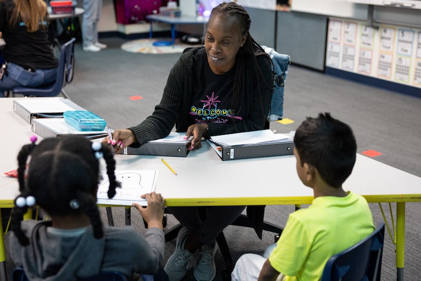 Dorsha Richmond, a paraprofessional for students with disabilities, helps Structured...