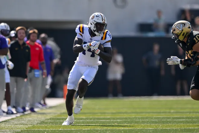 Oct 18, 2025; Nashville, Tennessee, USA; Louisiana State Tigers tight end Trey'Dez Green (14) runs with the ball after a made catch against the Vanderbilt Commodores during the first half at FirstBank Stadium. Mandatory Credit: Steve Roberts-Imagn Images