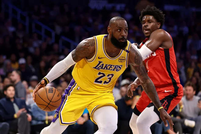 LOS ANGELES, CALIFORNIA - APRIL 11: LeBron James #23 of the Los Angeles Lakers drives past Aaron Holiday #0 of the Houston Rockets during the second quarter at Crypto.com Arena on April 11, 2025 in Los Angeles, California. NOTE TO USER: User expressly acknowledges and agrees that, by downloading and or using this photograph, User is consenting to the terms and conditions of the Getty Images License Agreement. (Photo by Katelyn Mulcahy/Getty Images)