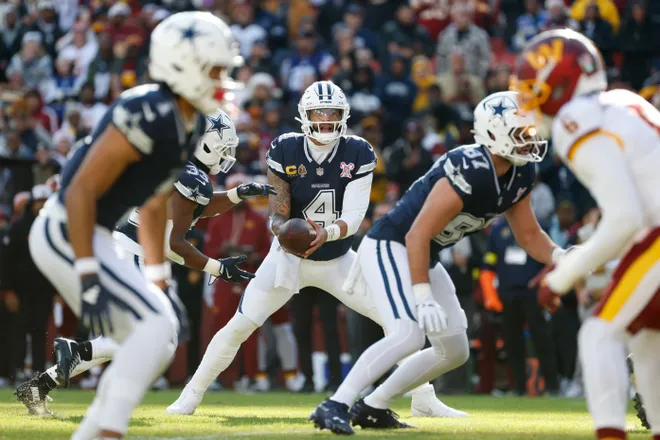 Dec 25, 2025; Landover, Maryland, USA; Dallas Cowboys quarterback Dak Prescott (4) looks to hand off the ball to running back Javonte Williams (33) against the Washington Commanders in the first quarter at Northwest Stadium. Mandatory Credit: Amber Searls-Imagn Images