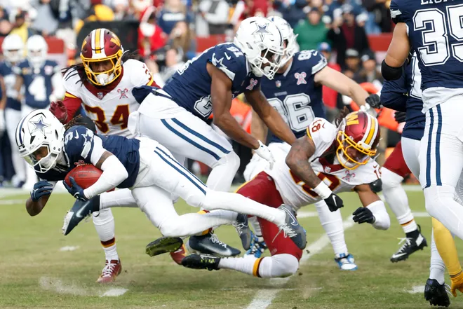 Dec 25, 2025; Landover, Maryland, USA; Washington Commanders safety Tyler Owens (18) tackles Dallas Cowboys wide receiver Kavontae Turpin (9) in the first quarter at Northwest Stadium. Mandatory Credit: Geoff Burke-Imagn Images