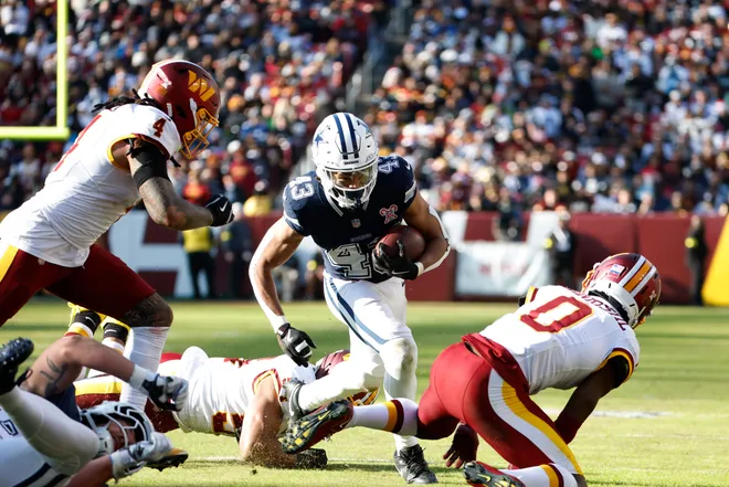 Dec 25, 2025; Landover, Maryland, USA; Dallas Cowboys running back Malik Davis (43) carries the ball as Washington Commanders linebacker Frankie Luvu (4) defends during the first half at Northwest Stadium. Mandatory Credit: Amber Searls-Imagn Images