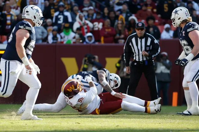 Dec 25, 2025; Landover, Maryland, USA; Dallas Cowboys quarterback Dak Prescott (4) is sacked by Washington Commanders defensive tackle Jer'Zhan Newton (95) during the first half at Northwest Stadium. Mandatory Credit: Amber Searls-Imagn Images