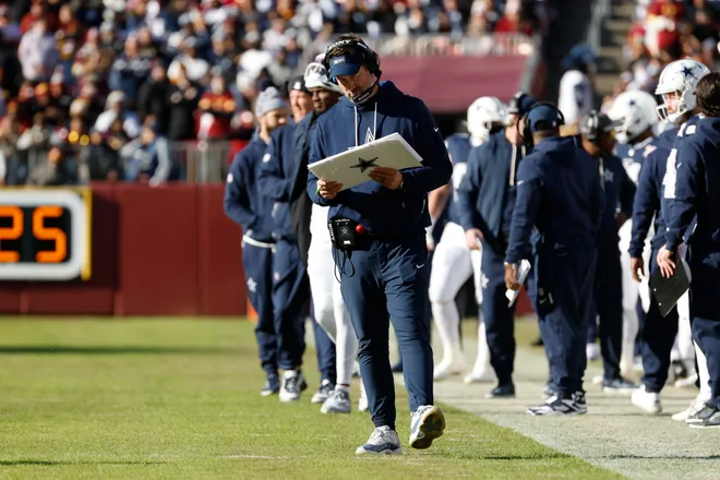 Dec 25, 2025; Landover, Maryland, USA; Dallas Cowboys head coach Brian Schottenheimer (center) looks on from the sidelines against the Washington Commanders during the first half at Northwest Stadium. Mandatory Credit: Amber Searls-Imagn Images