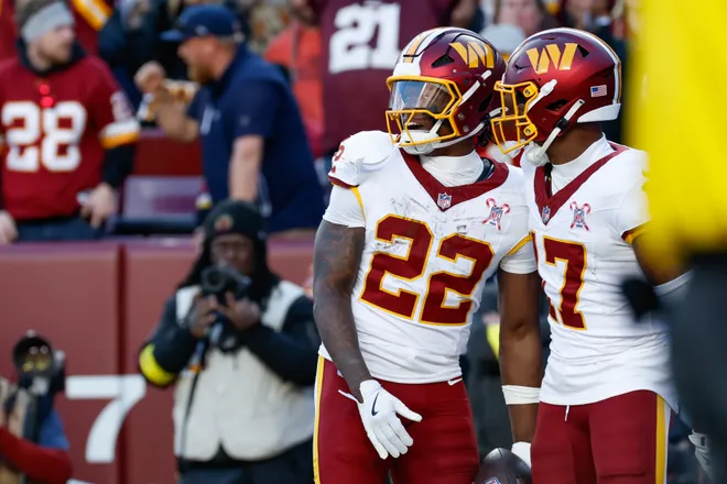 Dec 25, 2025; Landover, Maryland, USA; Washington Commanders running back Jacory Croskey-Merritt (22) celebrates after scoring a touchdown against the Dallas Cowboys with wide receiver Terry McLaurin (17) in the second quarter at Northwest Stadium. Mandatory Credit: Amber Searls-Imagn Images