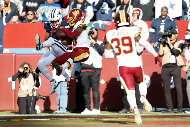 Dec 25, 2025; Landover, Maryland, USA; Washington Commanders cornerback Mike Sainristil (0) breaks up a touchdown pass intended for Dallas Cowboys wide receiver Jalen Tolbert (1) in the second quarter at Northwest Stadium. Mandatory Credit: Geoff Burke-Imagn Images