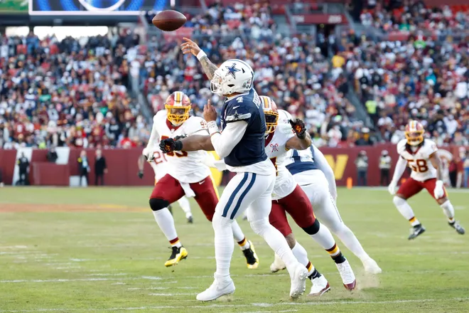 Dec 25, 2025; Landover, Maryland, USA; Dallas Cowboys quarterback Dak Prescott (4) passes the ball under pressure from Washington Commanders linebacker Bobby Wagner (54) in the second quarter at Northwest Stadium. Mandatory Credit: Geoff Burke-Imagn Images