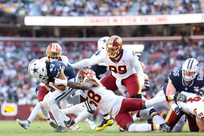 Dec 25, 2025; Landover, Maryland, USA; Washington Commanders linebacker Jordan Magee (58) tackles Dallas Cowboys running back Malik Davis (43) in the second quarter at Northwest Stadium. Mandatory Credit: Geoff Burke-Imagn Images