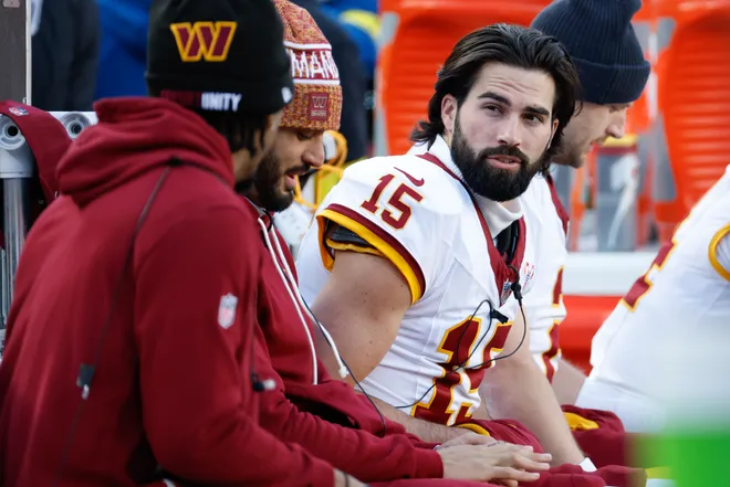Dec 25, 2025; Landover, Maryland, USA; Washington Commanders quarterback Sam Hartman (15) looks on from the bench in the third quarter against the Dallas Cowboys at Northwest Stadium. Mandatory Credit: Amber Searls-Imagn Images