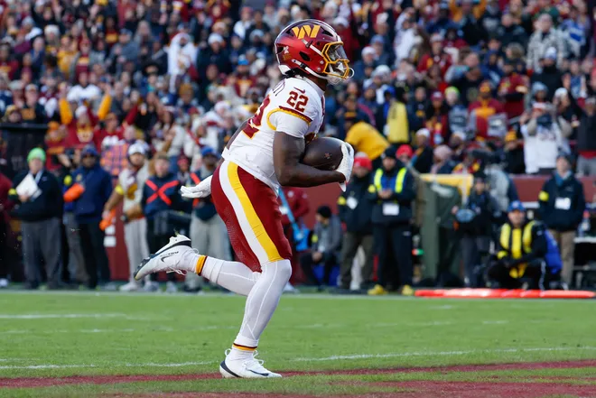 Dec 25, 2025; Landover, Maryland, USA; Washington Commanders running back Jacory Croskey-Merritt (22) carries the ball for a touchdown against the Dallas Cowboys in the second quarter at Northwest Stadium. Mandatory Credit: Amber Searls-Imagn Images