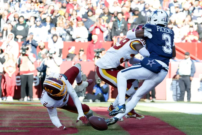 Dec 25, 2025; Landover, Maryland, USA; Washington Commanders cornerback Noah Igbinoghene (6) and safety Jeremy Reaves (39) break up a touchdown pass intended for Dallas Cowboys wide receiver George Pickens (3) in the second quarter at Northwest Stadium. Mandatory Credit: Geoff Burke-Imagn Images