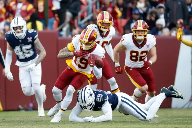 Dec 25, 2025; Landover, Maryland, USA; Dallas Cowboys cornerback C.J. Goodwin (29) tackles Washington Commanders wide receiver Chris Moore (19) in the third quarter at Northwest Stadium. Mandatory Credit: Amber Searls-Imagn Images