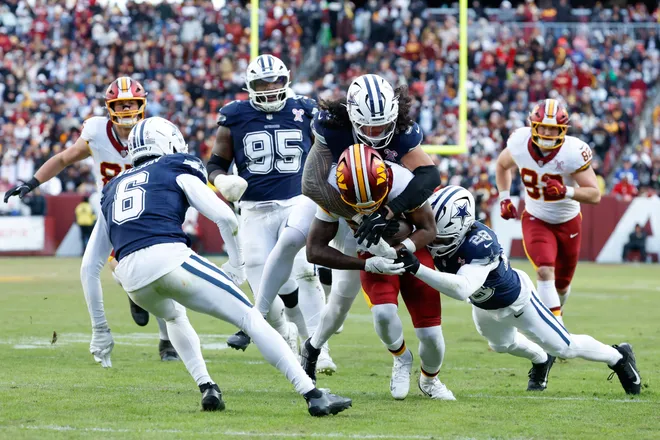 Dec 25, 2025; Landover, Maryland, USA; Dallas Cowboys linebacker Marist Liufau (35) and safety Malik Hooker (28) tackle Washington Commanders running back Jacory Croskey-Merritt (22) in the third quarter at Northwest Stadium. Mandatory Credit: Amber Searls-Imagn Images