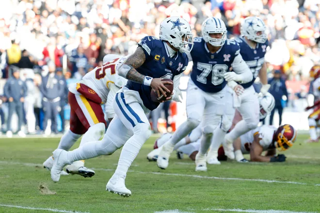Dec 25, 2025; Landover, Maryland, USA; Dallas Cowboys quarterback Dak Prescott (4) scrambles with the ball defended by Washington Commanders defensive tackle Jer'Zhan Newton (95) in the second quarter at Northwest Stadium. Mandatory Credit: Geoff Burke-Imagn Images