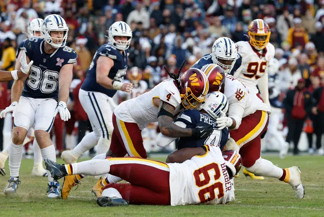 Dec 25, 2025; Landover, Maryland, USA; Washington Commanders linebacker Frankie Luvu (4), defensive tackle Ricky Barber (66) and defensive tackle Jer'Zhan Newton (95) tackle Dallas Cowboys quarterback Dak Prescott (4) in the fourth quarter at Northwest Stadium. Mandatory Credit: Geoff Burke-Imagn Images