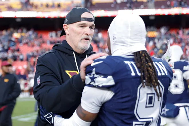Dec 25, 2025; Landover, Maryland, USA; Washington Commanders head coach Dan Quinn speaks to Dallas Cowboys wide receiver Kavontae Turpin (9) after the game at Northwest Stadium. Mandatory Credit: Amber Searls-Imagn Images