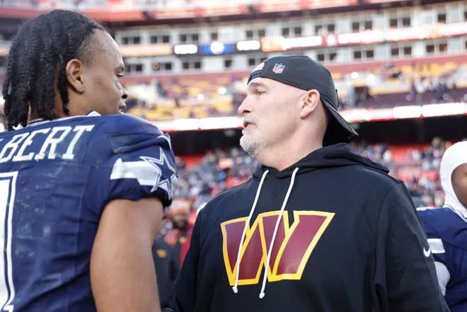 Dec 25, 2025; Landover, Maryland, USA; Washington Commanders head coach Dan Quinn speaks to Dallas Cowboys wide receiver Jalen Tolbert (1) after the game at Northwest Stadium. Mandatory Credit: Amber Searls-Imagn Images