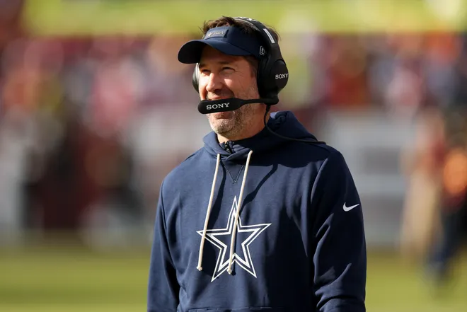 LANDOVER, MARYLAND - DECEMBER 25: Head coach Brian Schottenheimer of the Dallas Cowboys looks on in the first quarter of a game against the Washington Commanders at Northwest Stadium on December 25, 2025 in Landover, Maryland. (Photo by Scott Taetsch/Getty Images)