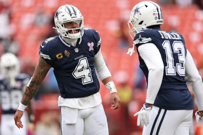 LANDOVER, MARYLAND - DECEMBER 25: Dak Prescott #4 and Dante Fowler Jr. #13 of the Dallas Cowboys talk prior to a game against the Washington Commanders at Northwest Stadium on December 25, 2025 in Landover, Maryland. (Photo by Scott Taetsch/Getty Images)