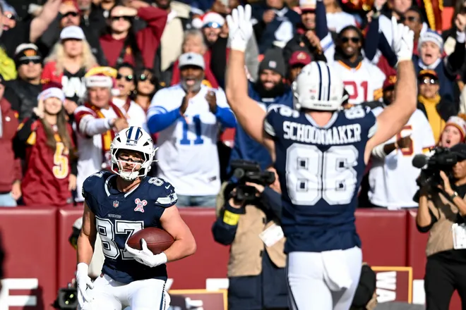LANDOVER, MARYLAND - DECEMBER 25: Jake Ferguson #87 and Luke Schoonmaker #86 of the Dallas Cowboys react after Ferguson's receiving touchdown against the Washington Commanders in the first quarter of a game at Northwest Stadium on December 25, 2025 in Landover, Maryland. (Photo by Greg Fiume/Getty Images)