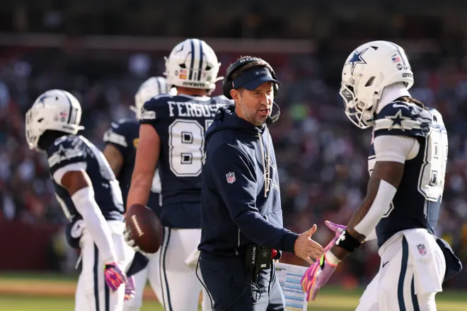 LANDOVER, MARYLAND - DECEMBER 25: Head coach Brian Schottenheimer and Ceedee Lamb #88 of the Dallas Cowboys high five after their team's touchdown against the Washington Commanders in the first quarter of a game at Northwest Stadium on December 25, 2025 in Landover, Maryland. (Photo by Scott Taetsch/Getty Images)