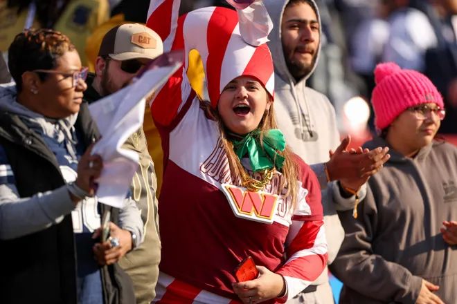 LANDOVER, MARYLAND - DECEMBER 25: A fan dressed as The Grinch cheers prior to a game between the Dallas Cowboys and the Washington Commanders at Northwest Stadium on December 25, 2025 in Landover, Maryland. (Photo by Scott Taetsch/Getty Images)