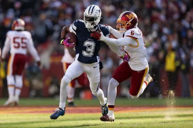 LANDOVER, MARYLAND - DECEMBER 25: Noah Igbinoghene #6 of the Washington Commanders tackles George Pickens #3 of the Dallas Cowboys in the first quarter of a game at Northwest Stadium on December 25, 2025 in Landover, Maryland. (Photo by Scott Taetsch/Getty Images)