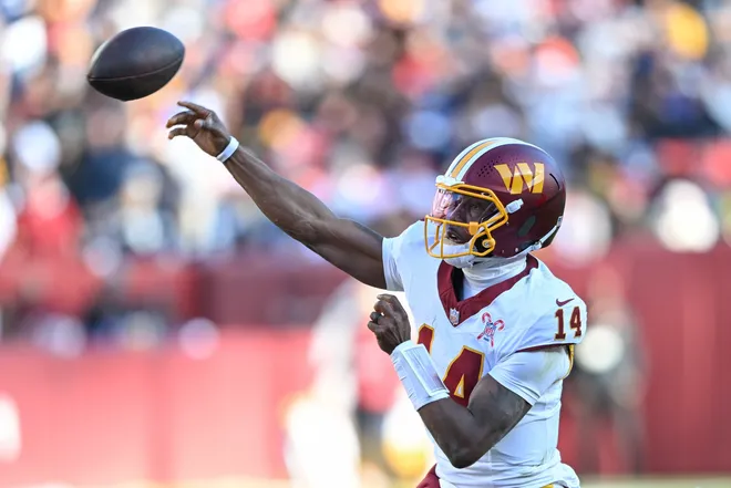 LANDOVER, MARYLAND - DECEMBER 25: Josh Johnson #14 of the Washington Commanders looks to pass against the Dallas Cowboys in the second quarter of a game at Northwest Stadium on December 25, 2025 in Landover, Maryland. (Photo by Greg Fiume/Getty Images)