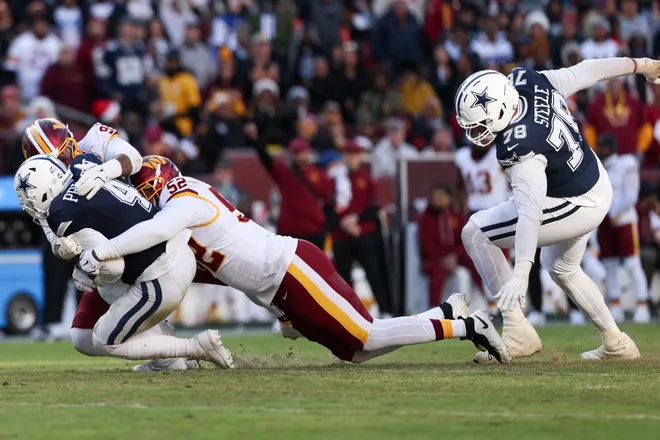LANDOVER, MARYLAND - DECEMBER 25: Javon Kinlaw #99 and Preston Smith #52 of the Washington Commanders sacks Dak Prescott #4 of the Dallas Cowboys in the second quarter of a game at Northwest Stadium on December 25, 2025 in Landover, Maryland. (Photo by Scott Taetsch/Getty Images)
