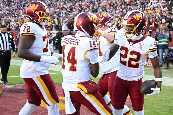 LANDOVER, MARYLAND - DECEMBER 25: Josh Johnson #14 and Jacory Croskey-Merritt #22 of the Washington Commanders celebrate after Croskey-Merritt's rushing touchdown in the second quarter of a game against the Dallas Cowboys at Northwest Stadium on December 25, 2025 in Landover, Maryland. (Photo by Greg Fiume/Getty Images)