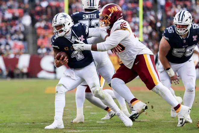 LANDOVER, MARYLAND - DECEMBER 25: Jerâ€™Zhan Newton #95 of the Washington Commanders sacks Dak Prescott #4 of the Dallas Cowboys in the third quarter of a game at Northwest Stadium on December 25, 2025 in Landover, Maryland. (Photo by Scott Taetsch/Getty Images)