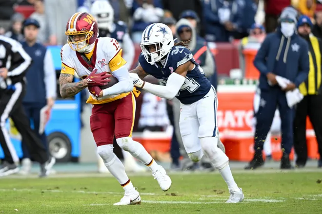 LANDOVER, MARYLAND - DECEMBER 25: Chris Moore #19 of the Washington Commanders catches a pass against Shavon Revel Jr. #34 of the Dallas Cowboys in the third quarter of a game at Northwest Stadium on December 25, 2025 in Landover, Maryland. (Photo by Greg Fiume/Getty Images)