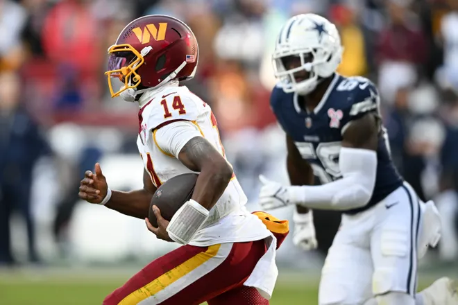 LANDOVER, MARYLAND - DECEMBER 25: Josh Johnson #14 of the Washington Commanders runs the ball against the Dallas Cowboys in the third quarter of a game at Northwest Stadium on December 25, 2025 in Landover, Maryland. (Photo by Greg Fiume/Getty Images)