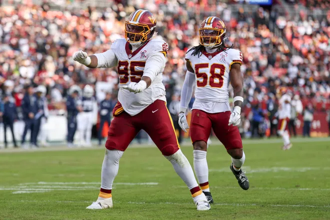 LANDOVER, MARYLAND - DECEMBER 25: Jer'Zhan Newton #95 and Jordan Magee #58 of the Washington Commanders celebrate after Newton's sack against the Dallas Cowboys in the third quarter of a game at Northwest Stadium on December 25, 2025 in Landover, Maryland. (Photo by Scott Taetsch/Getty Images)