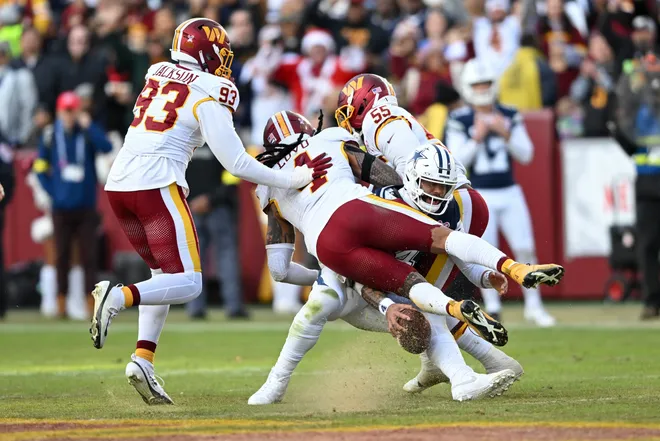 LANDOVER, MARYLAND - DECEMBER 25: Drake Jackson #93, Frankie Luvu #4, and Jacob Martin #55 of the Washington Commanders sack Dak Prescott #4 of the Dallas Cowboys in the third quarter of a game at Northwest Stadium on December 25, 2025 in Landover, Maryland. (Photo by Greg Fiume/Getty Images)