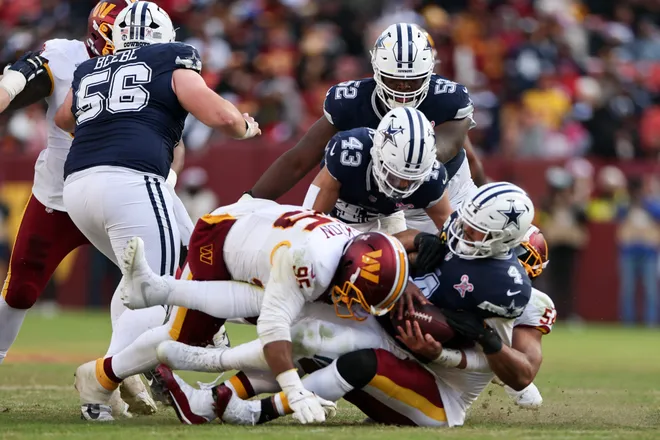 LANDOVER, MARYLAND - DECEMBER 25: Jer'Zhan Newton #95 of the Washington Commanders sacks Dak Prescott #4 of the Dallas Cowboys in the third quarter of a game at Northwest Stadium on December 25, 2025 in Landover, Maryland. (Photo by Scott Taetsch/Getty Images)