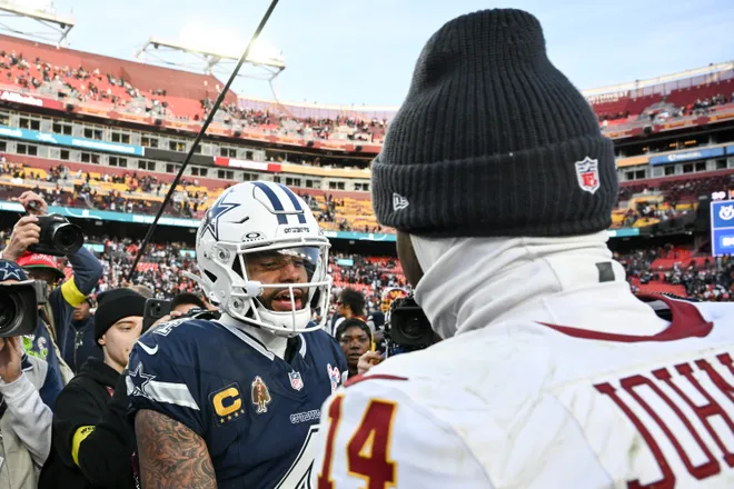 LANDOVER, MARYLAND - DECEMBER 25: Dak Prescott #4 of the Dallas Cowboys and Josh Johnson #14 of the Washington Commanders after Dallas' 30-23 victory at Northwest Stadium on December 25, 2025 in Landover, Maryland. (Photo by Greg Fiume/Getty Images)